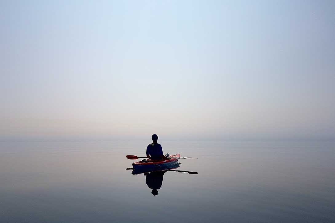 person in kayak on flat water