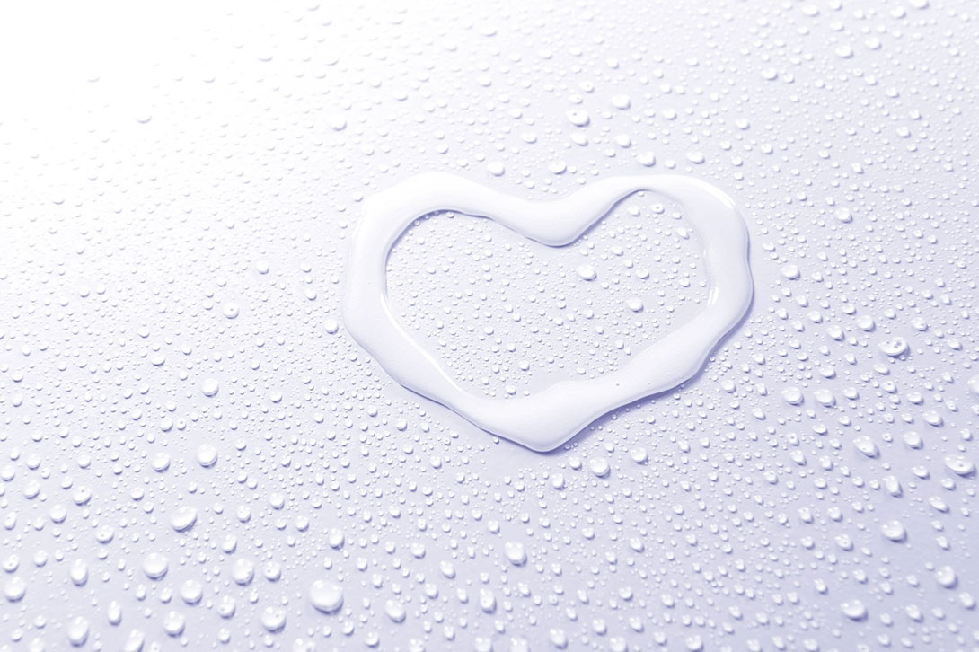 love heart drawn with water and surrounded by water drops