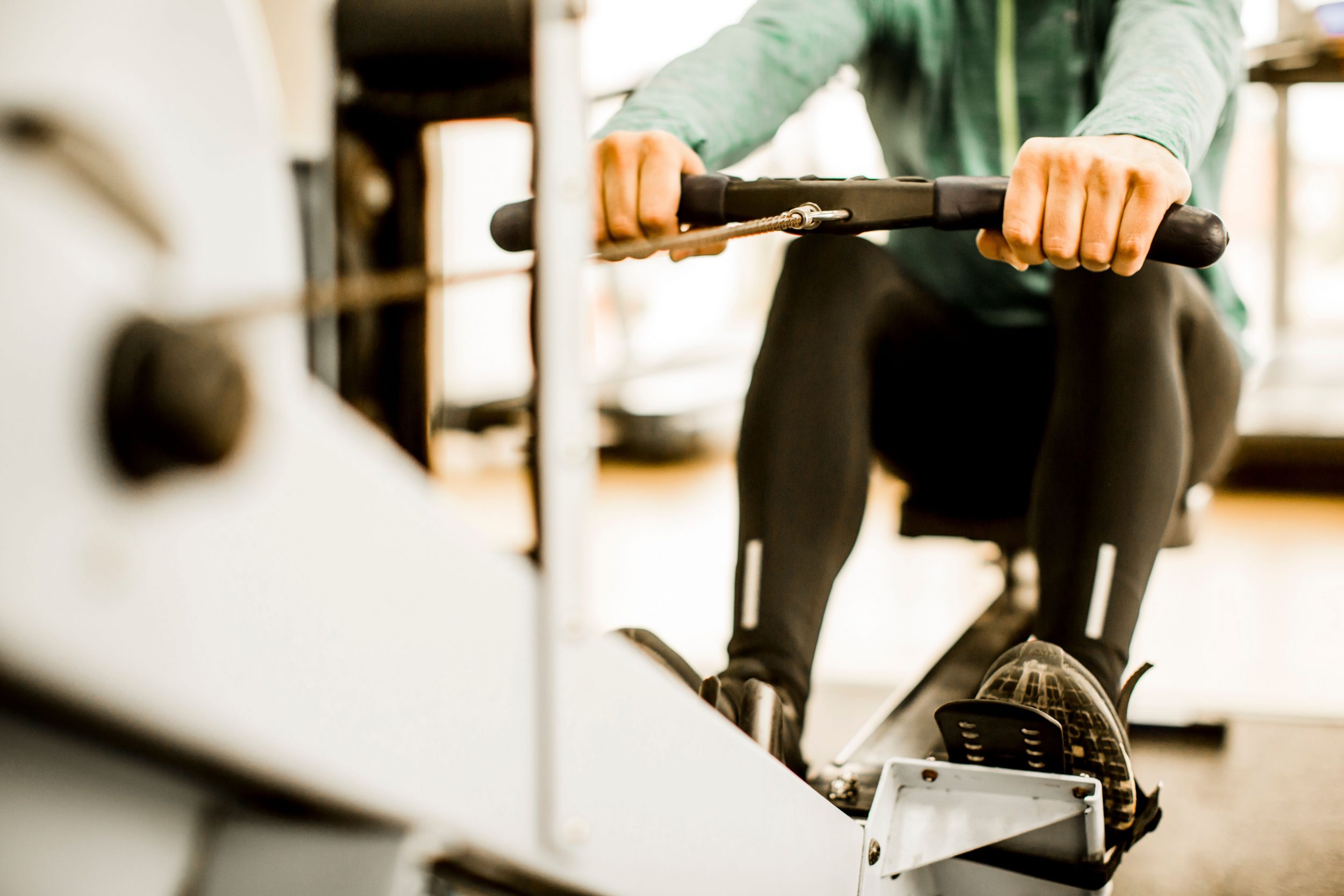 person using rowing machine