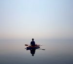 person in kayak on flat water
