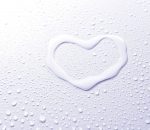 love heart drawn with water and surrounded by water drops